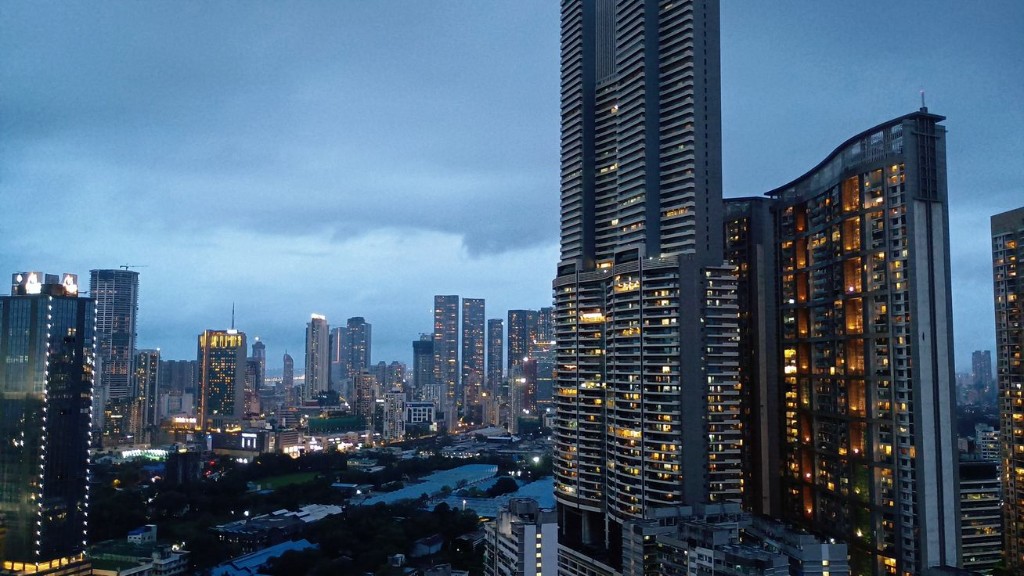 City skyline at dusk with illuminated high-rise buildings